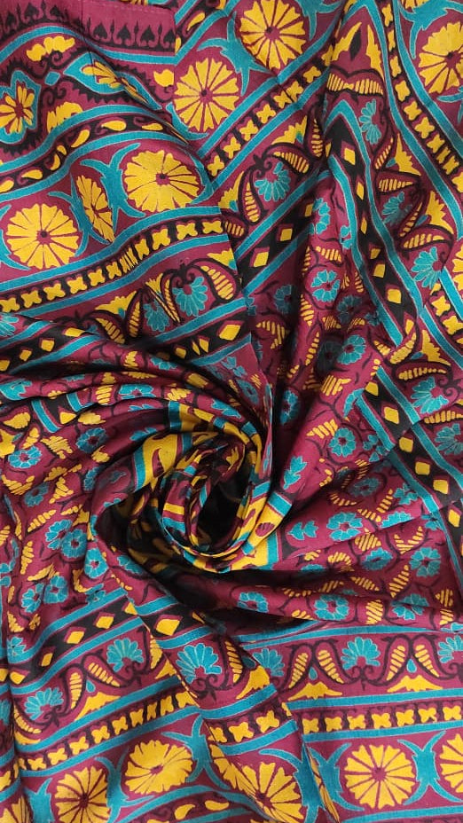 Colorful fabric with intricate patterns in red, yellow, blue, and purple.