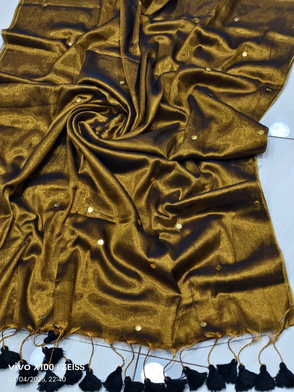 Ochre yellow handloom saree with shimmering black effect and black work and black tassels listed to order saree online.