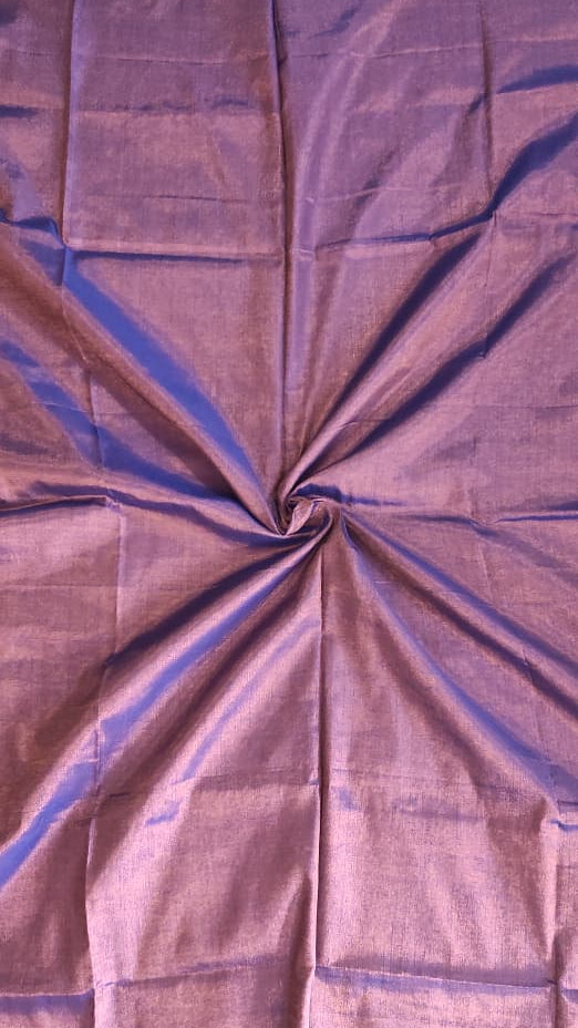 Zoomed picture of a Tissue silk handloom saree which is purple in colour with copper shimmer and blue tassels