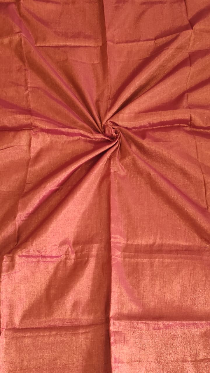 Tissue silk handloom saree which is red in colour with copper shimmer and pink tassels